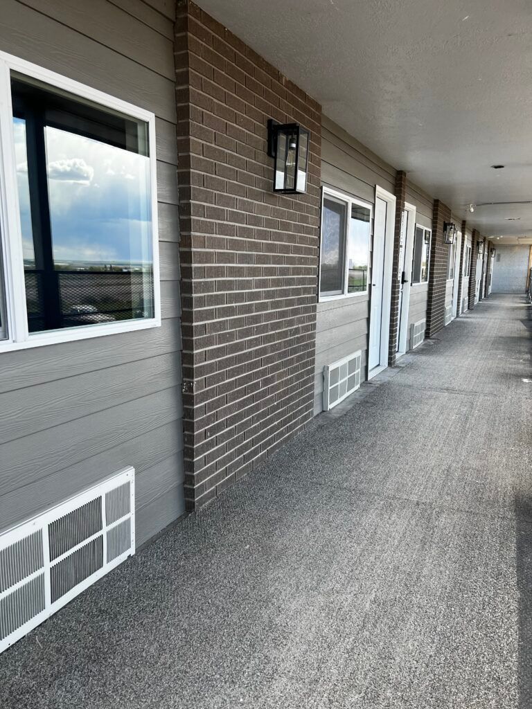 A long hallway with a lot of windows and doors