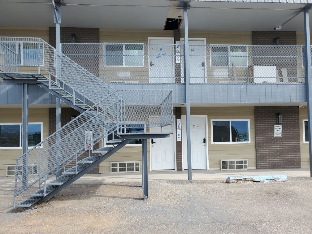 A building with stairs leading up to the second floor