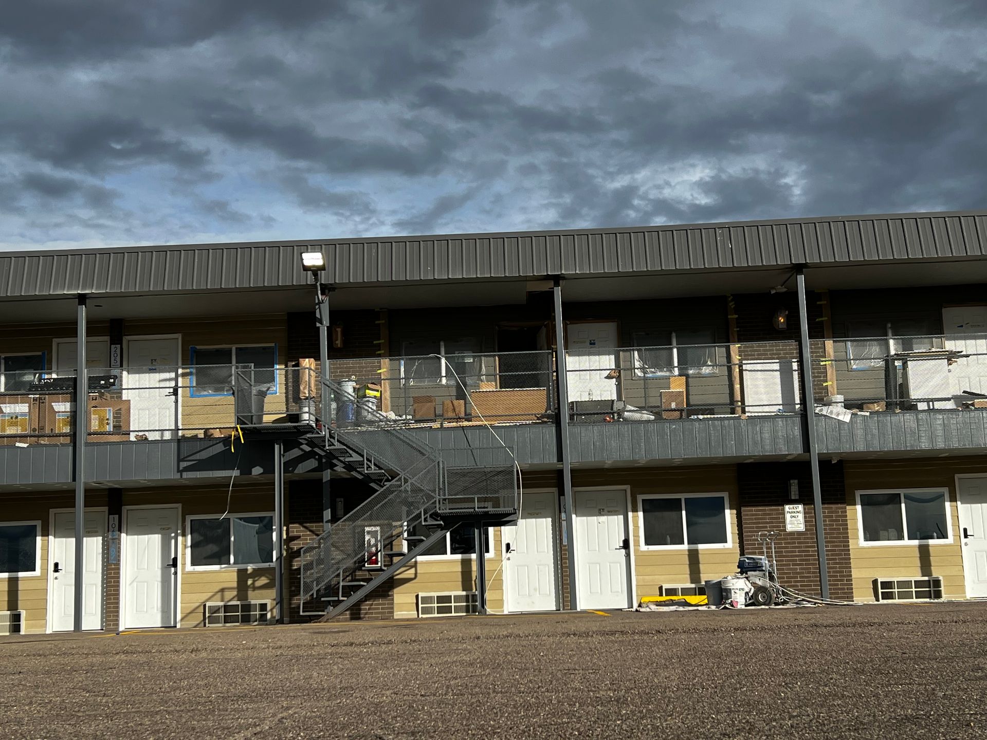 A large apartment building with stairs leading up to the second floor