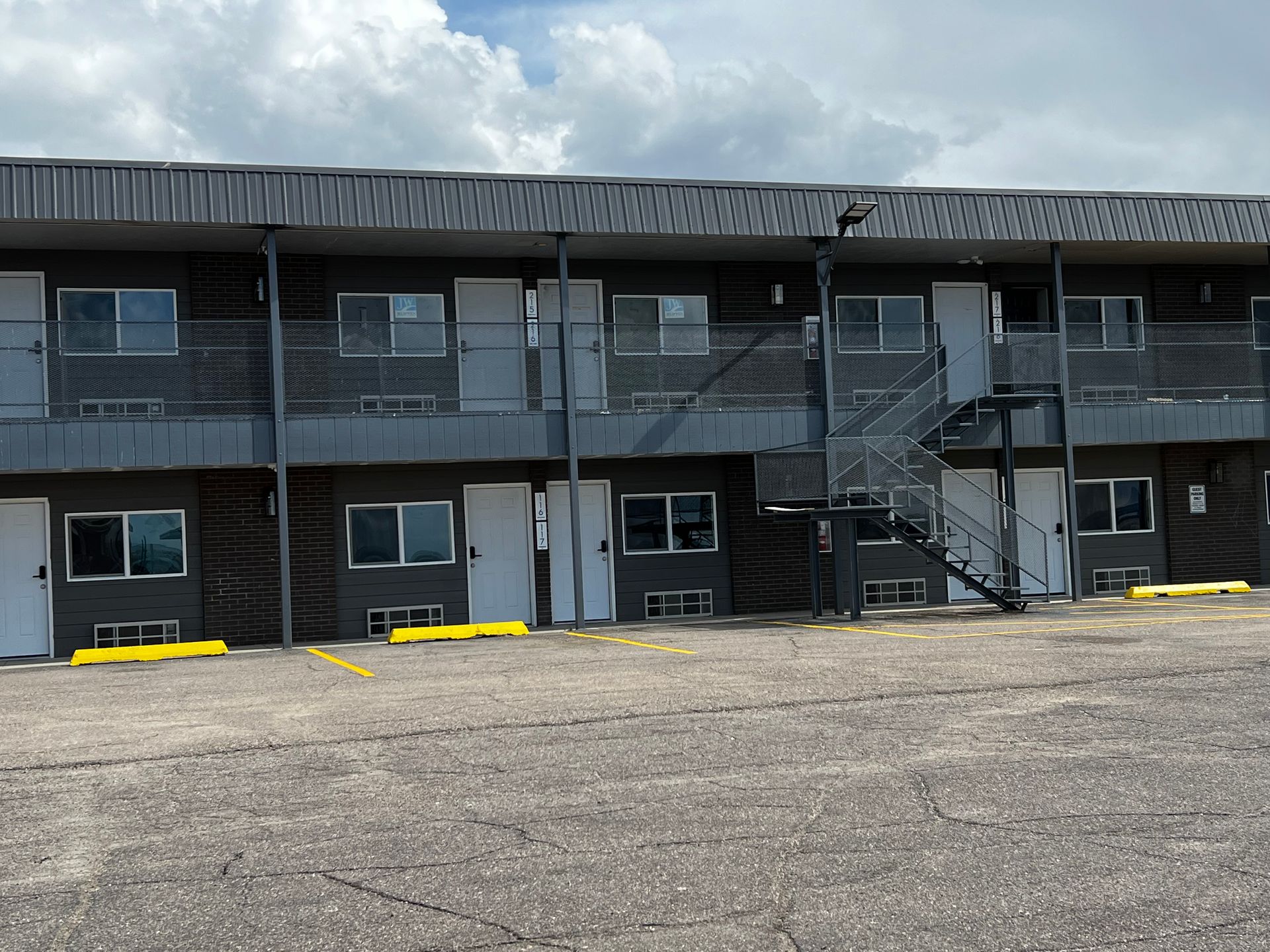 A motel with stairs leading up to the second floor