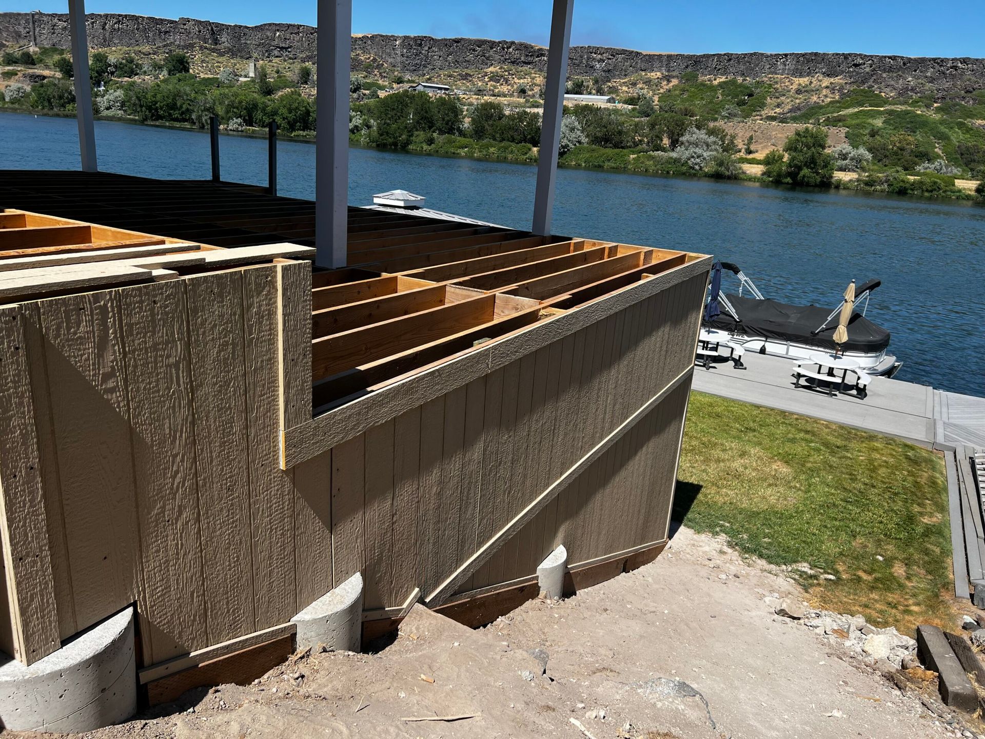 A building under construction with a view of a lake