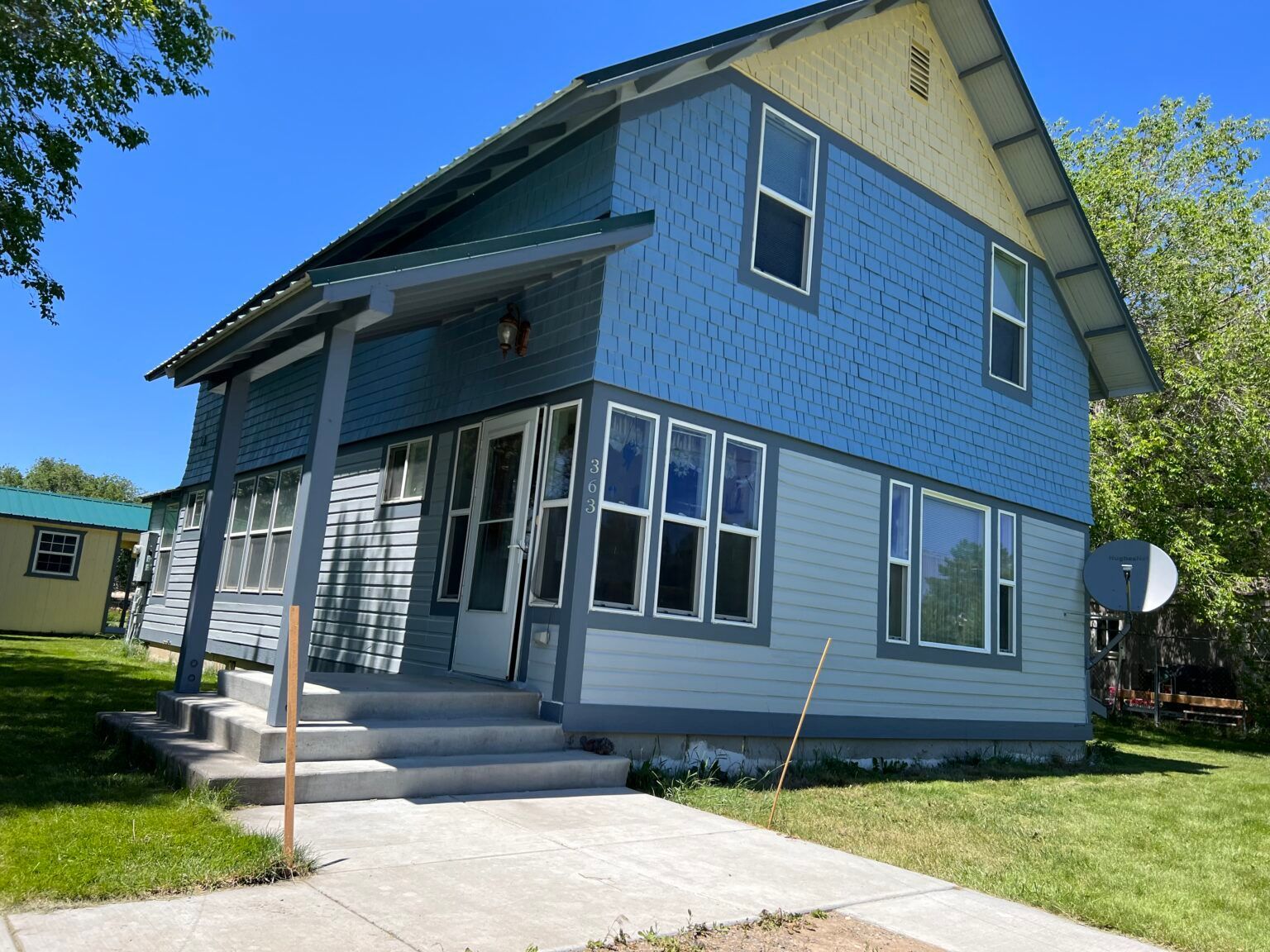 A blue and white house with a lot of windows