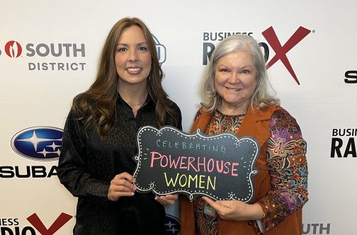 Two women are holding a sign that says powerhouse women