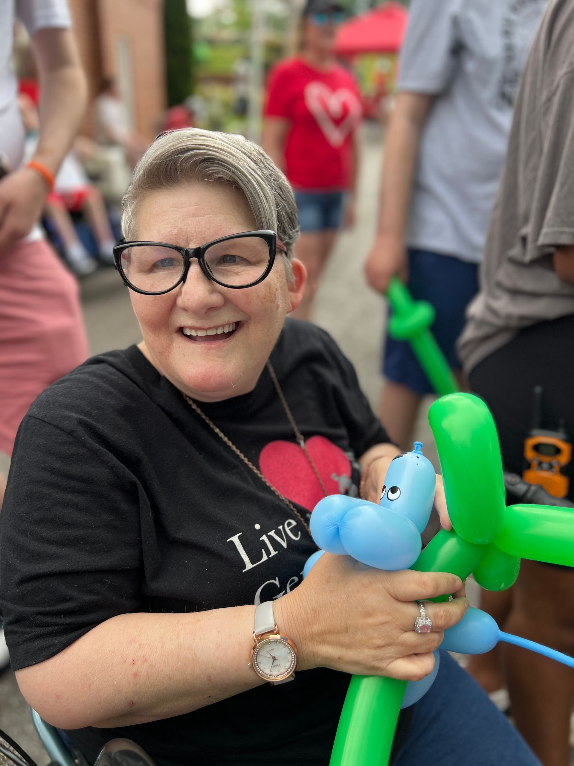 A woman in a black shirt that says live on it