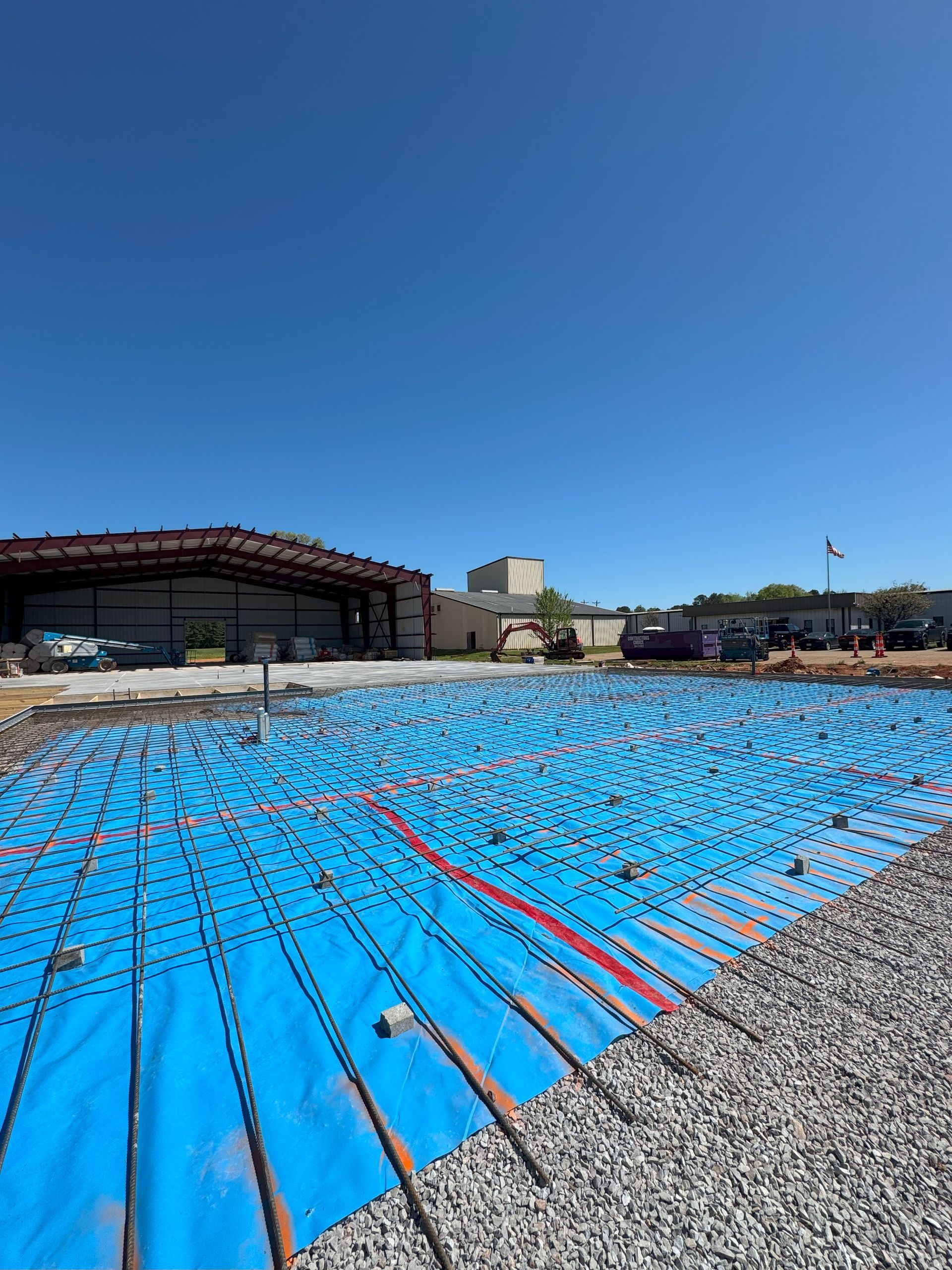 A large swimming pool with a blue tarp on top of it.