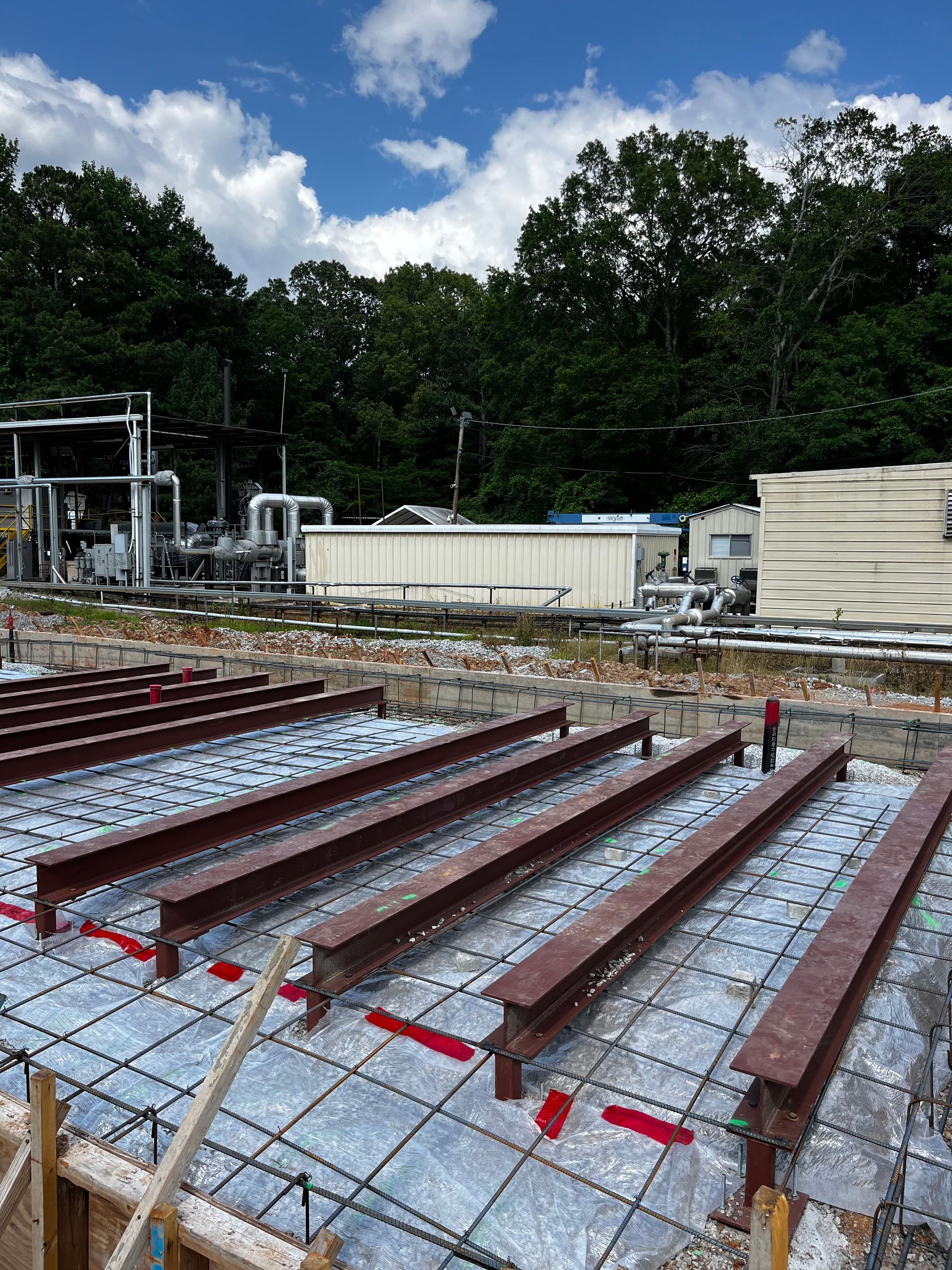 A construction site with a lot of concrete and steel beams.