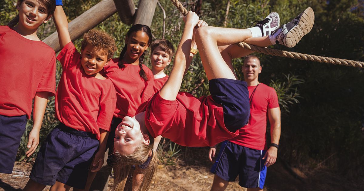 A group of children are doing a handstand on a rope.
