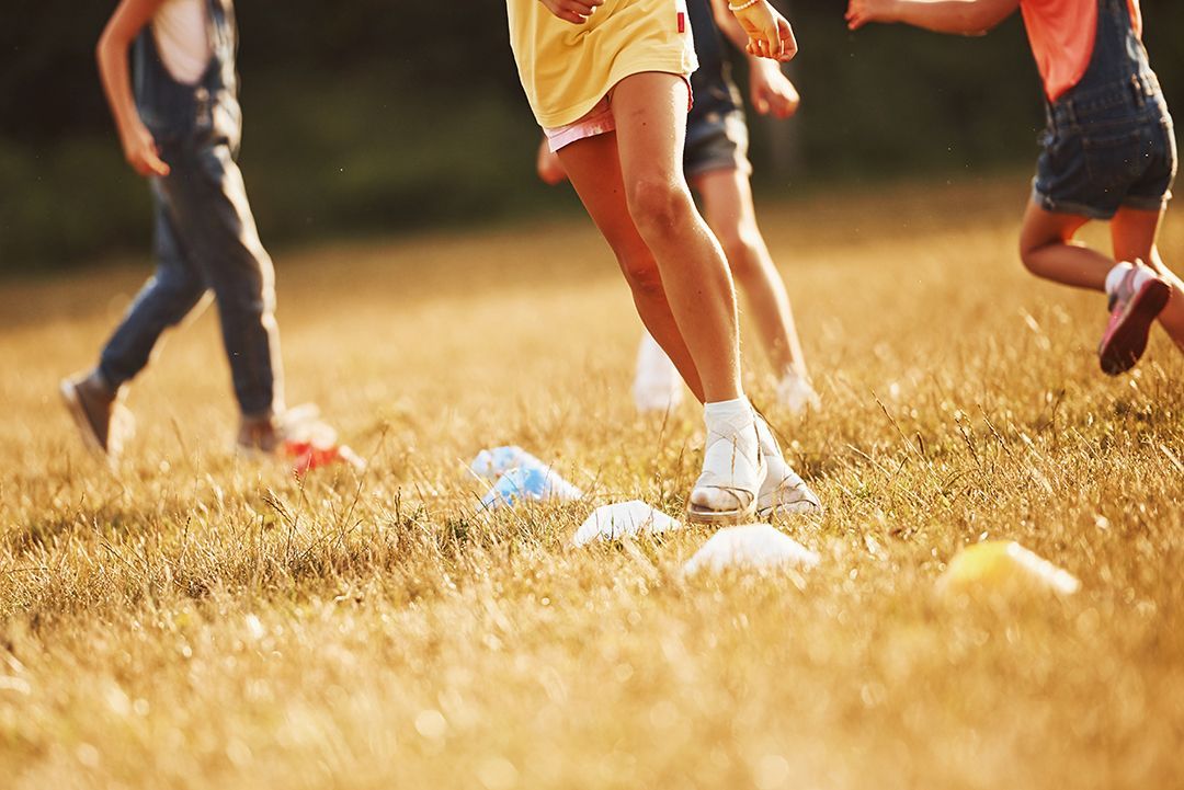A group of children are playing soccer in a field.