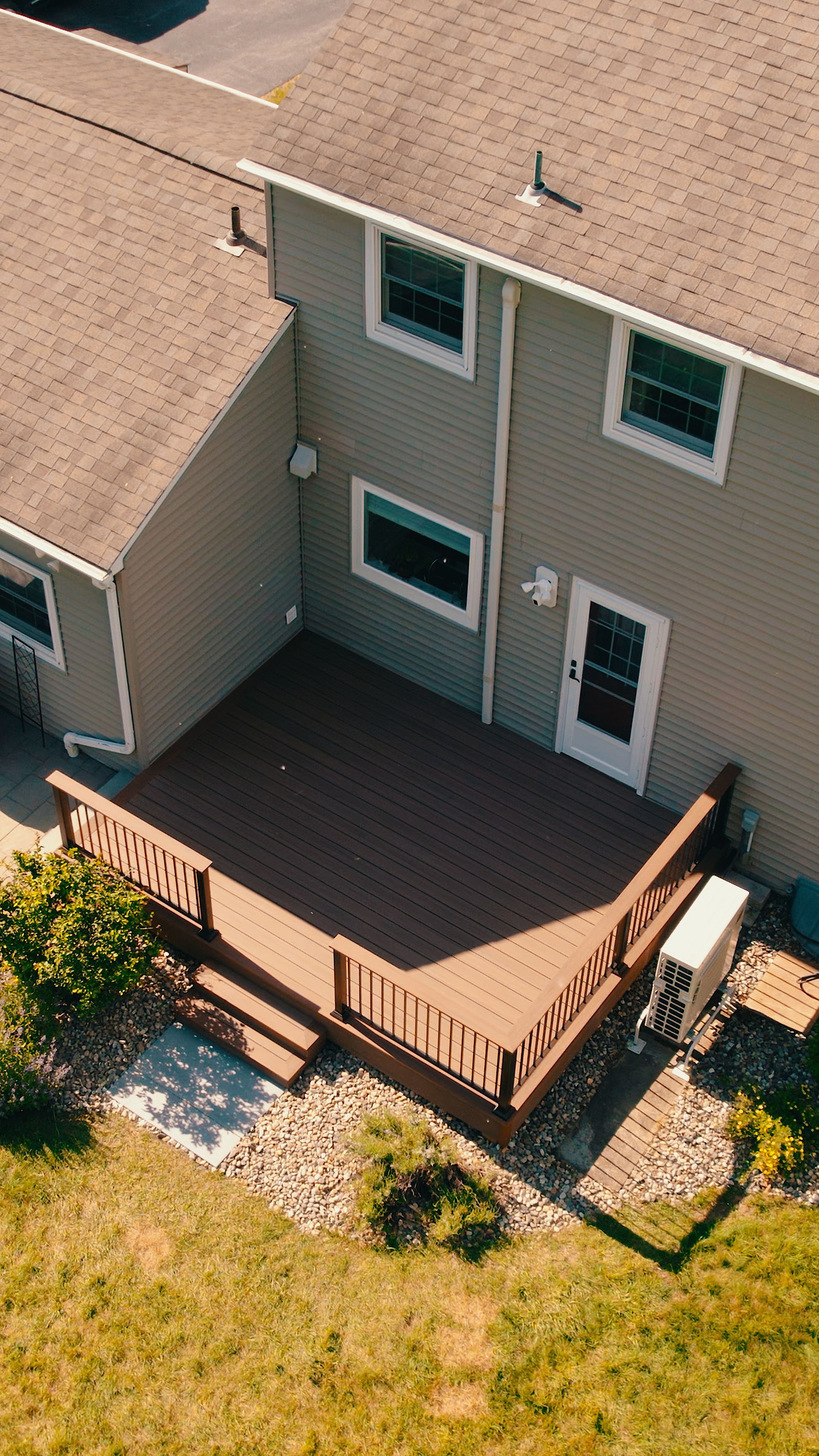 An aerial view of a house with a large deck.