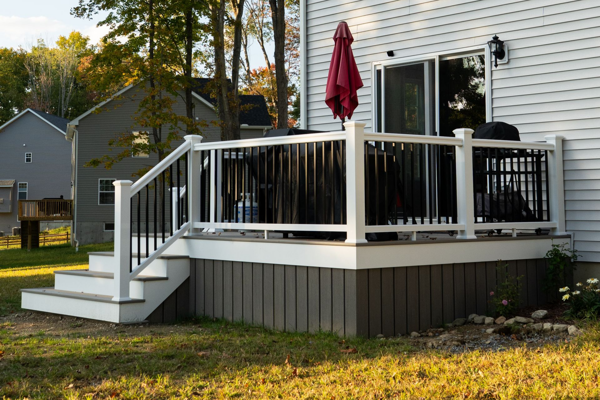 A deck with stairs leading up to it and lights on the steps.