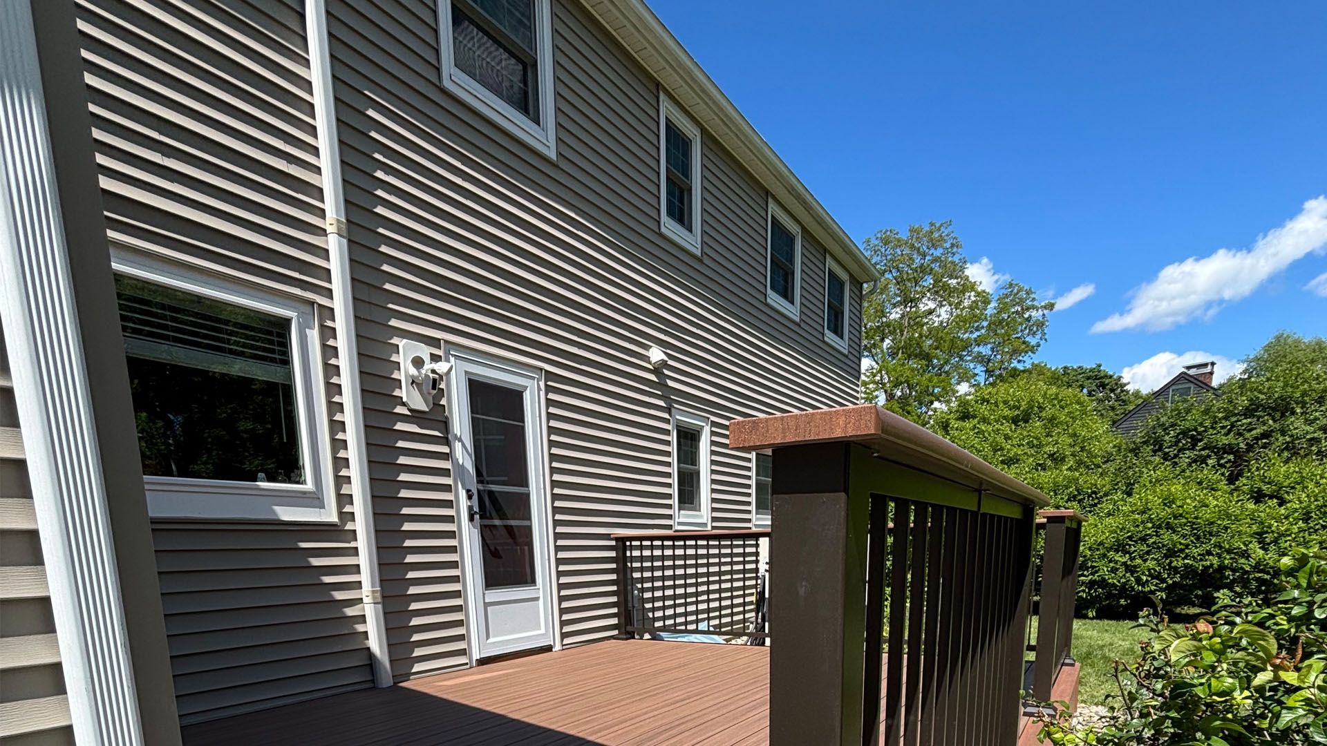 A large house with a large deck in front of it.