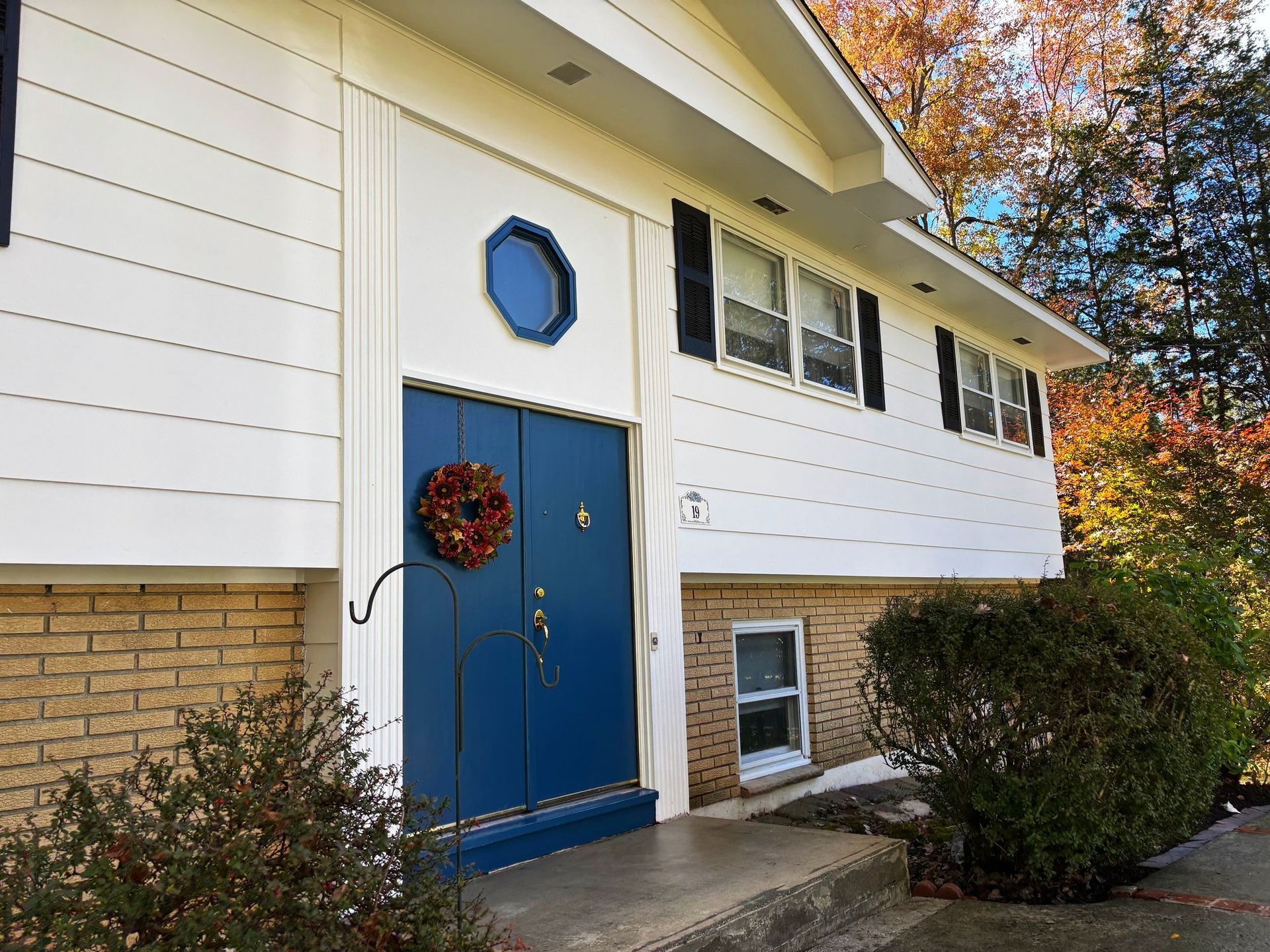 A house with a blue door and a wreath on it