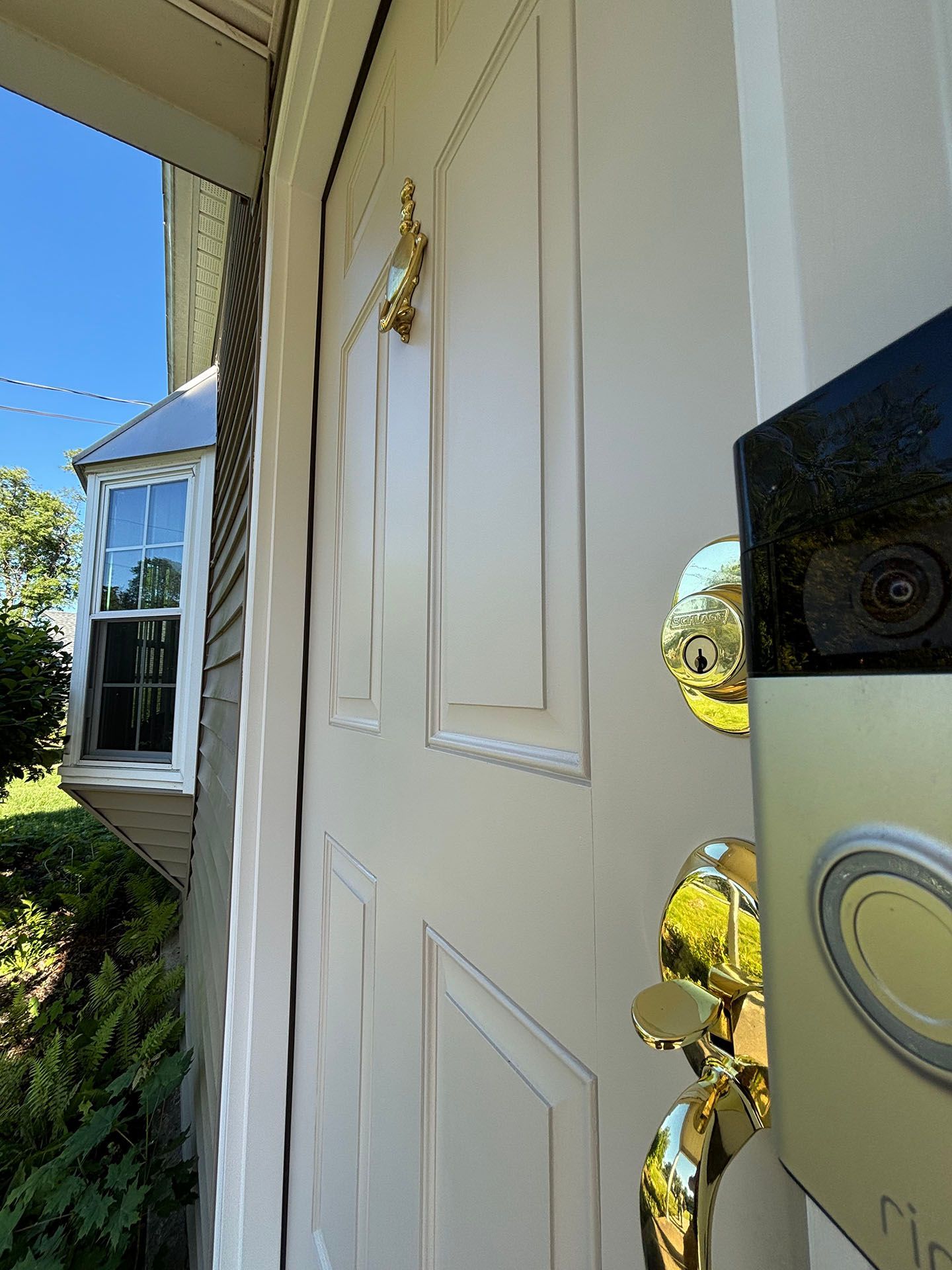 A close up of a door with a ring doorbell on it.
