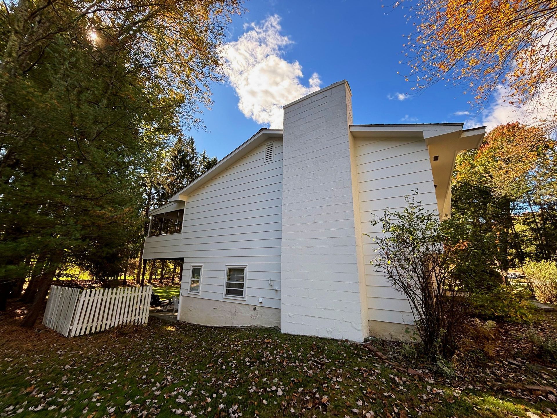 A white house with a white fence in front of it
