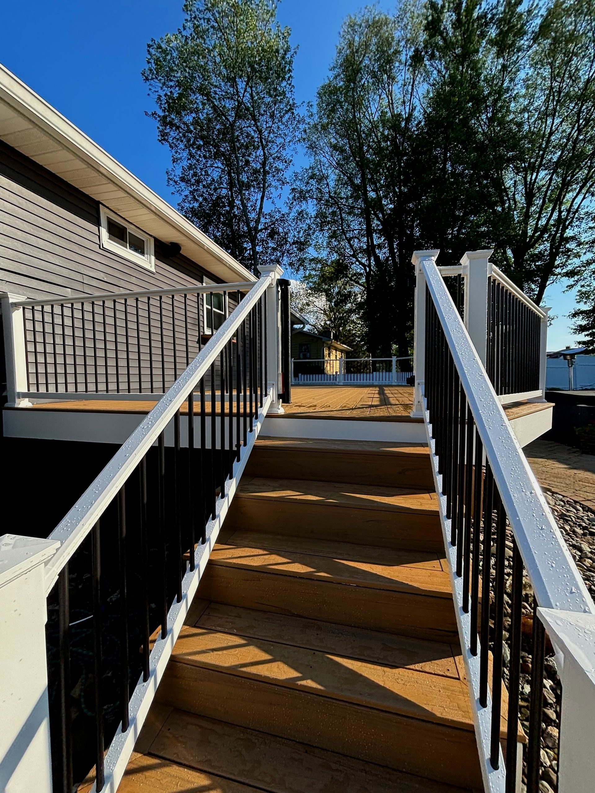 A wooden deck with stairs leading up to it