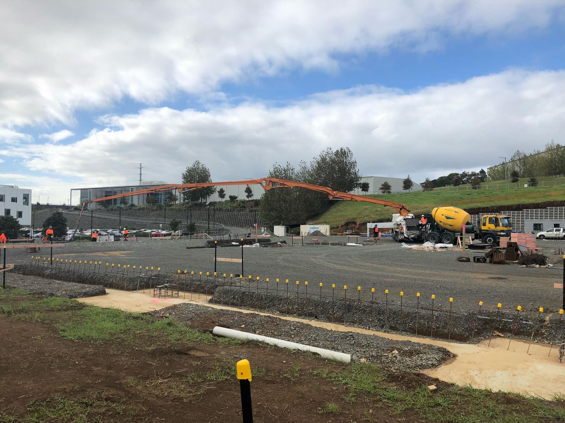 A construction site with a concrete pump in the middle of it.