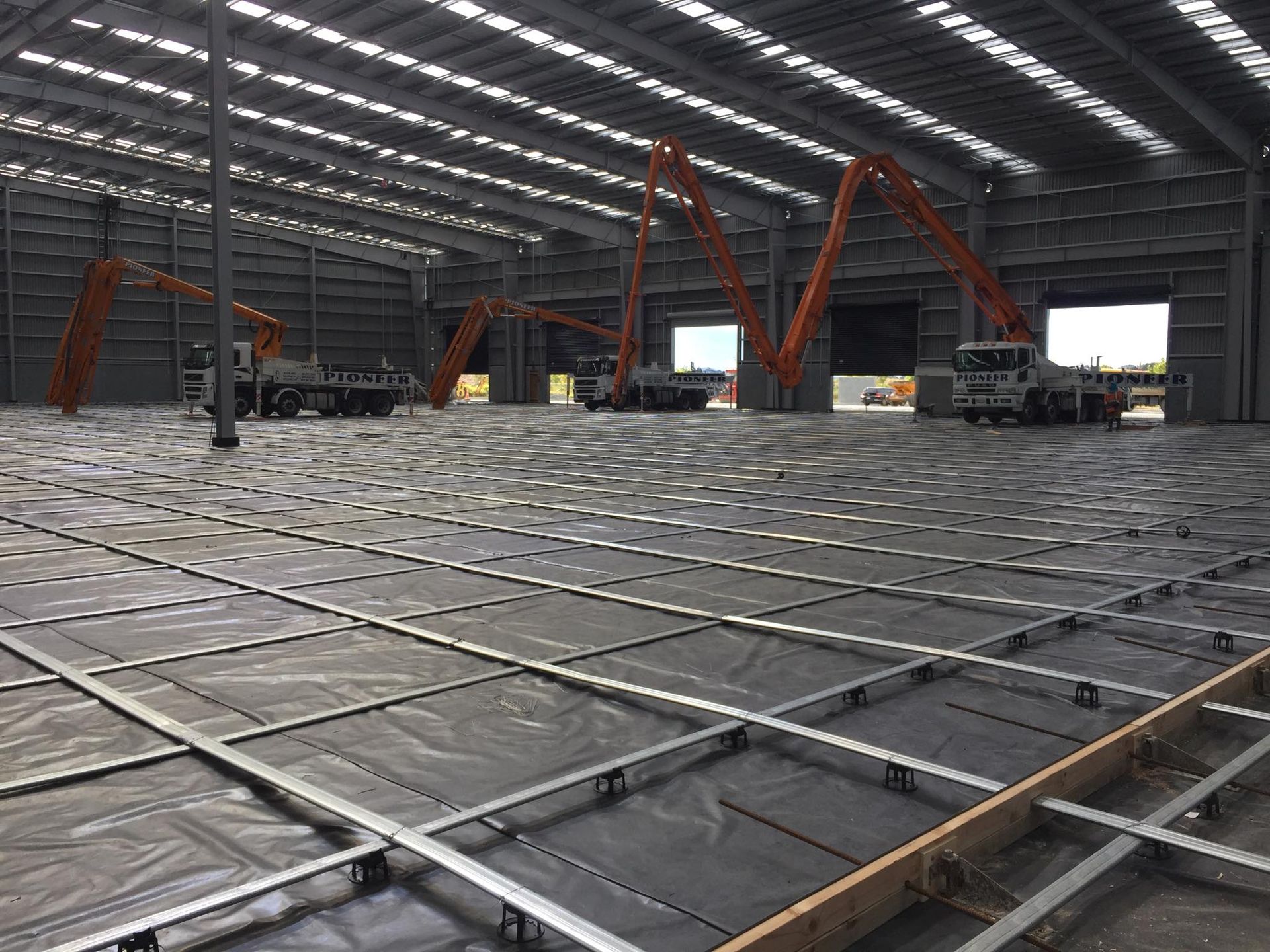 A large warehouse under construction with a lot of concrete in it.