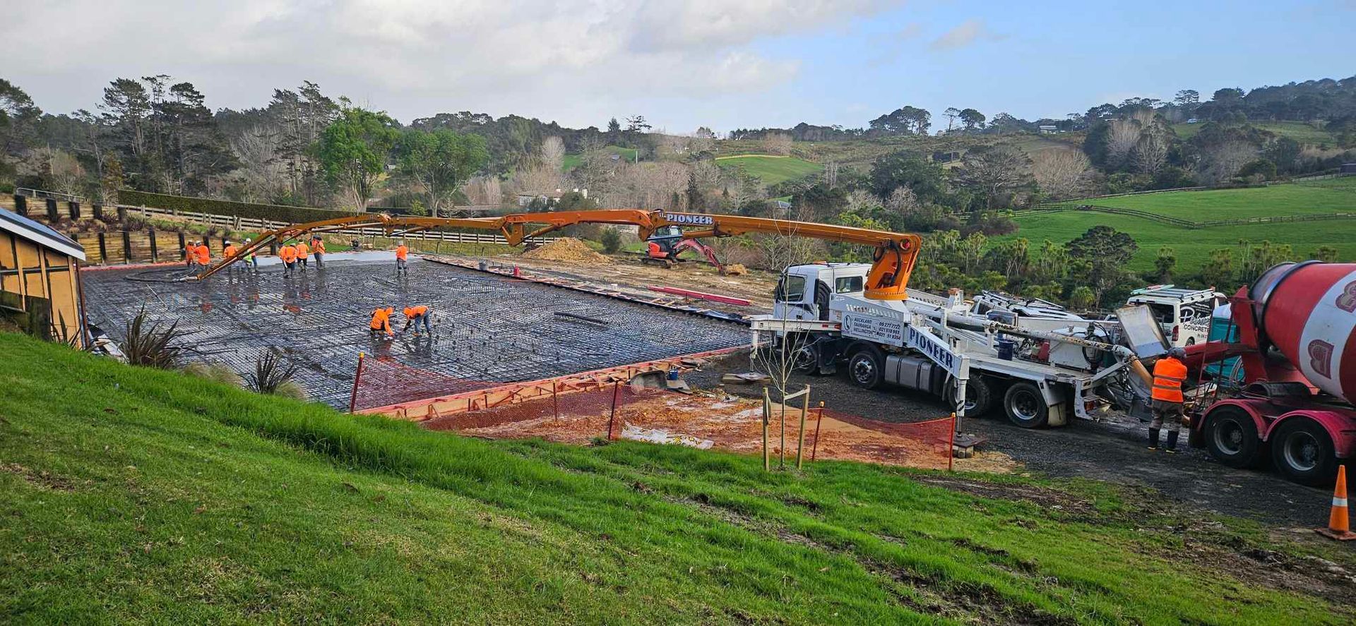 A concrete mixer is being used to pour concrete on a construction site.