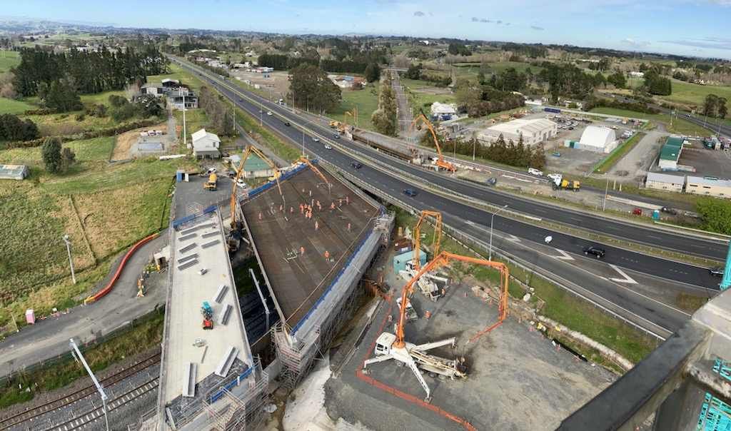An aerial view of a construction site next to a highway.