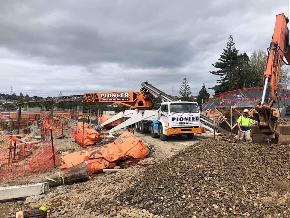 A construction site with a truck and a crane on it.