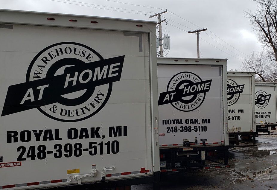 White delivery trucks lined up with
