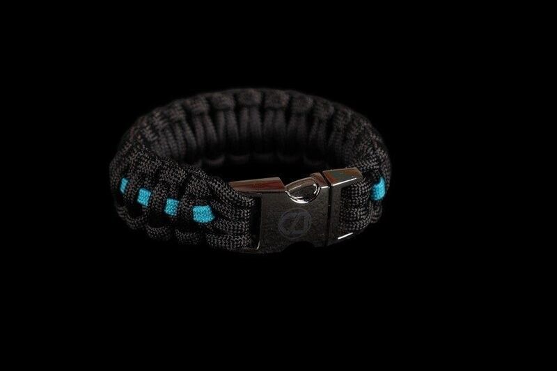 A black and blue paracord bracelet with a buckle on a black background.