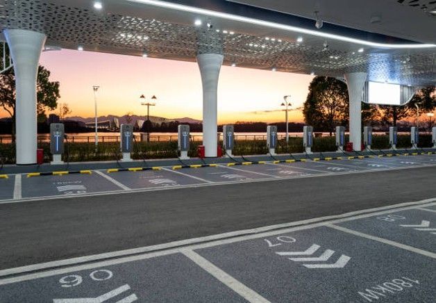 Electric vehicle charging station at sunset