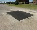 Asphalt patch on a cracked road