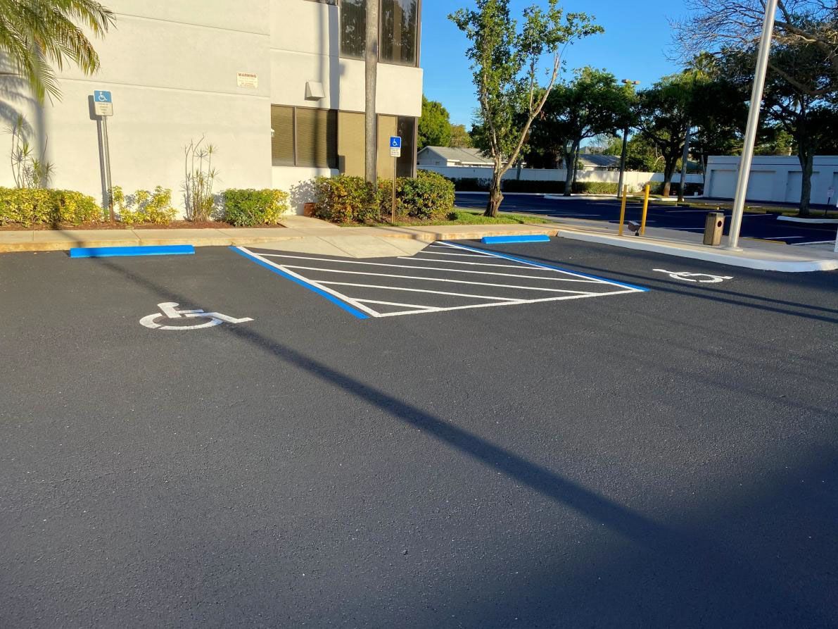 Asphalt parking lot with accessible parking space marked in blue and white