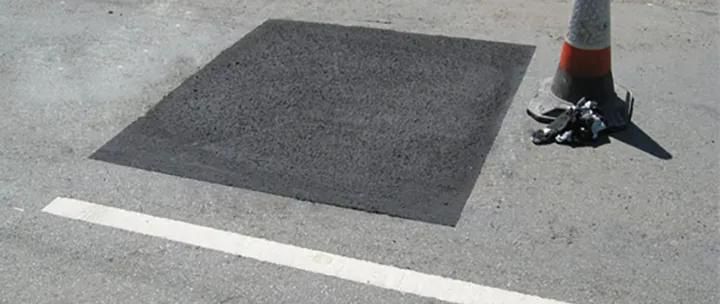 Empty rooftop parking lot beside modern buildings.