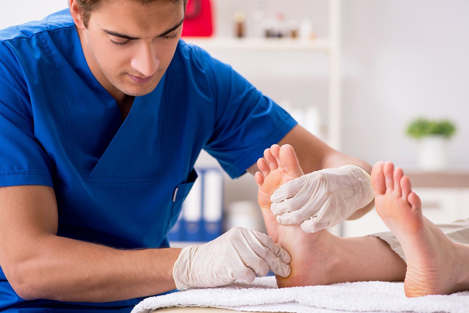 A foot doctor is treating feet during a procedure.