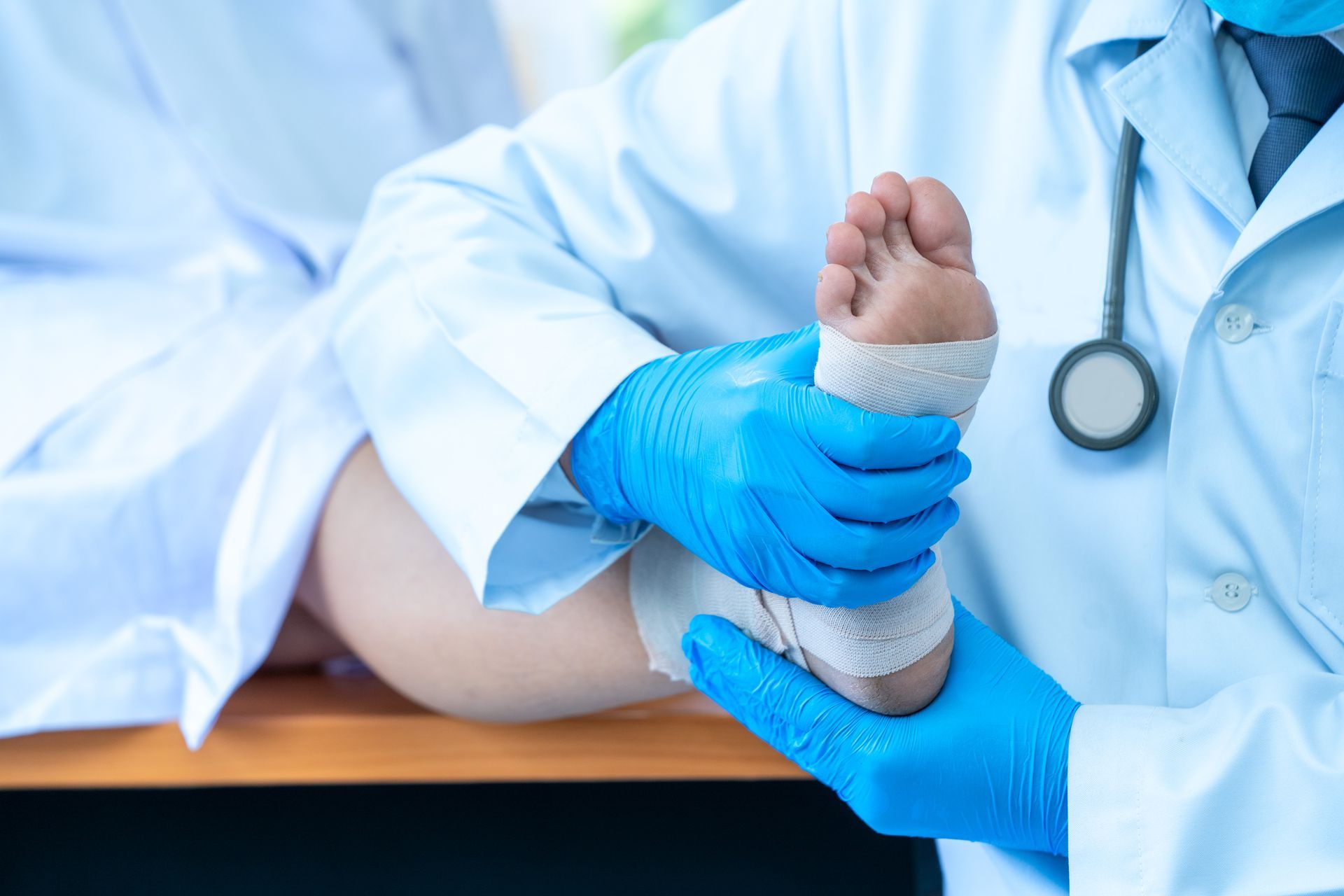 Podiatrist treating feet during procedure at clinic.