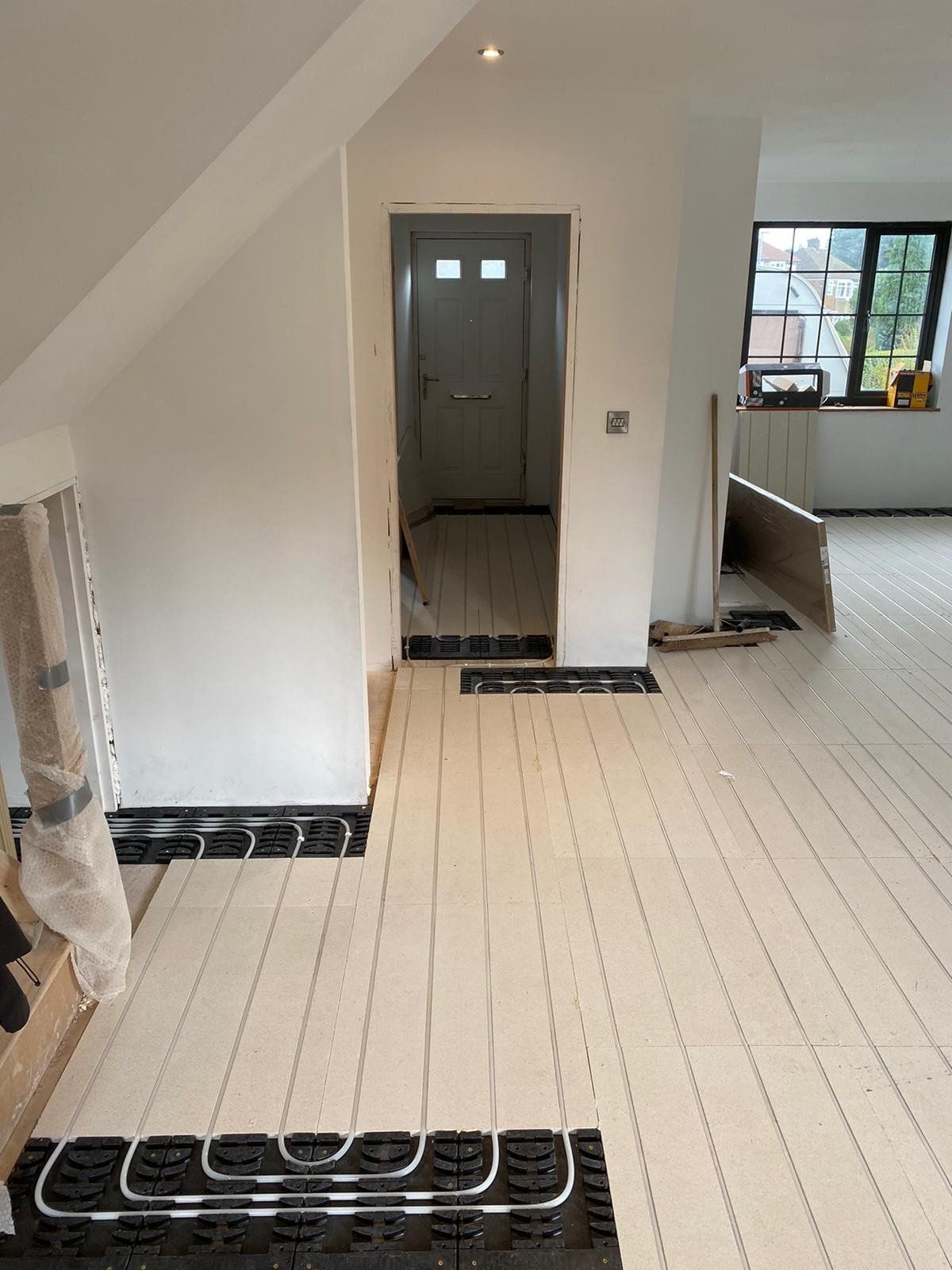 Tiled underfloor heating being fitted