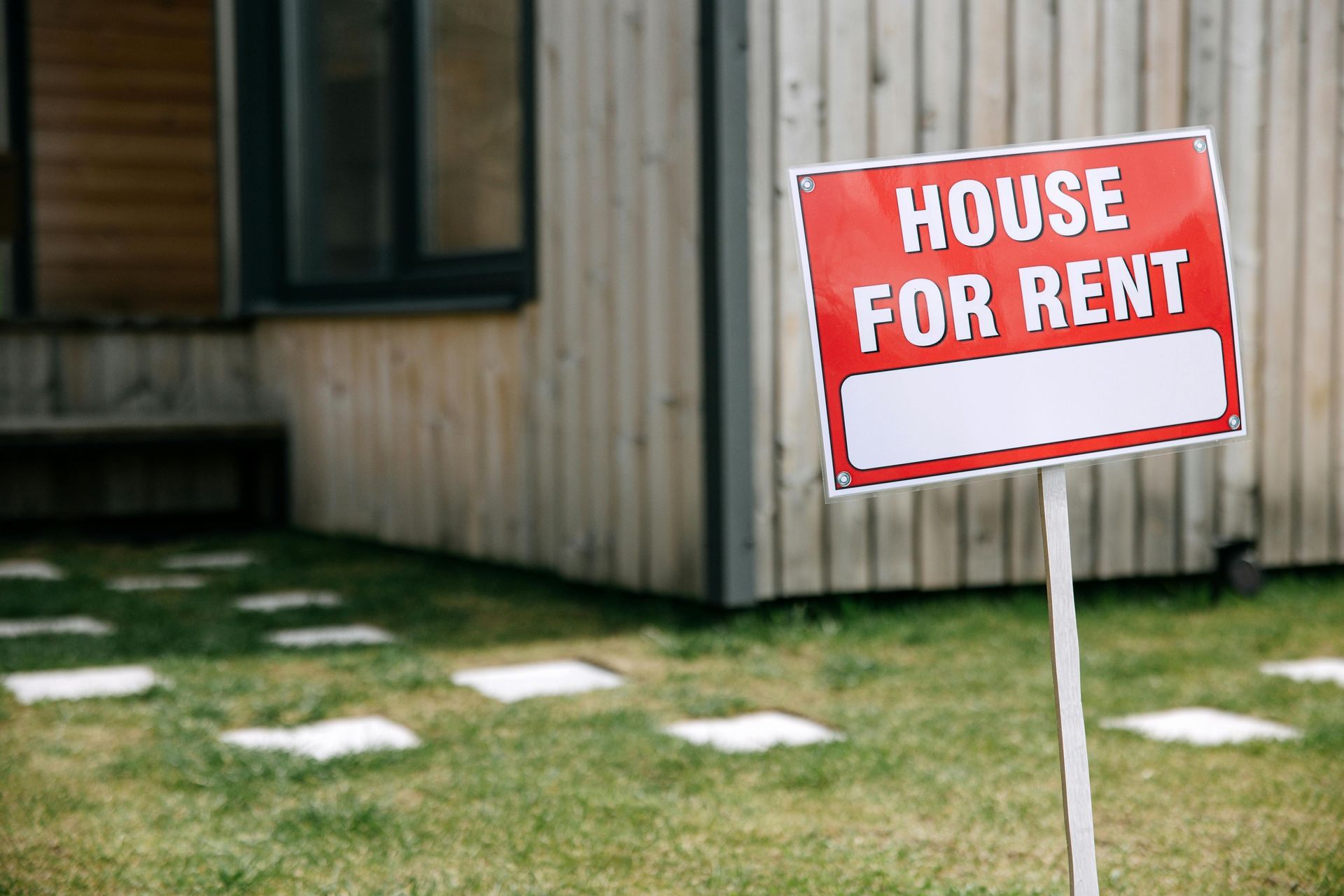 House for rent sign on lawn