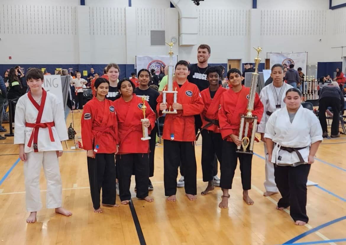 a group of people in karate uniforms are posing for a picture