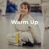 a young girl in a karate uniform is sitting on the floor .