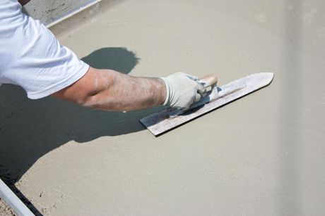 worker resurfacing the concrete floor