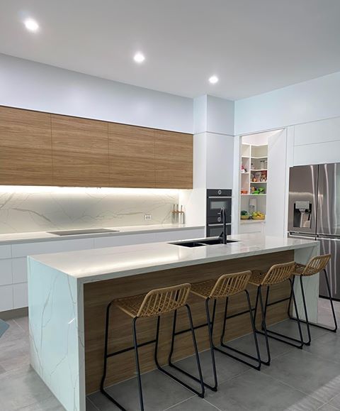 Kitchen with dim light and chairs — Cabinetry in Cairns, QLD