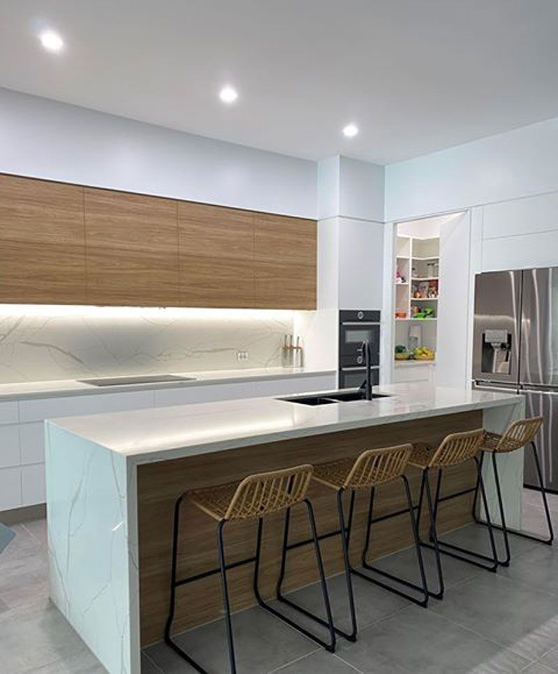 White table and brown kitchen furniture's — Cabinetry in Cairns, QLD