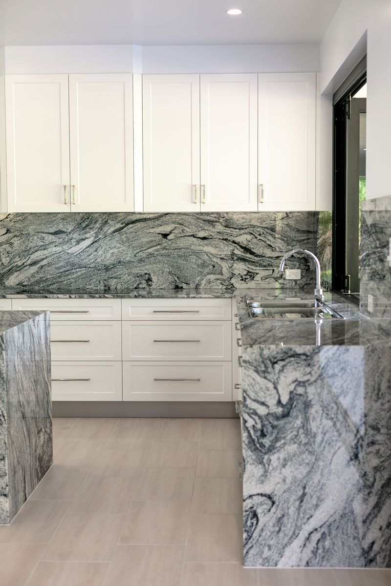 White cabinets and marble kitchen — Cabinetry in Cairns, QLD