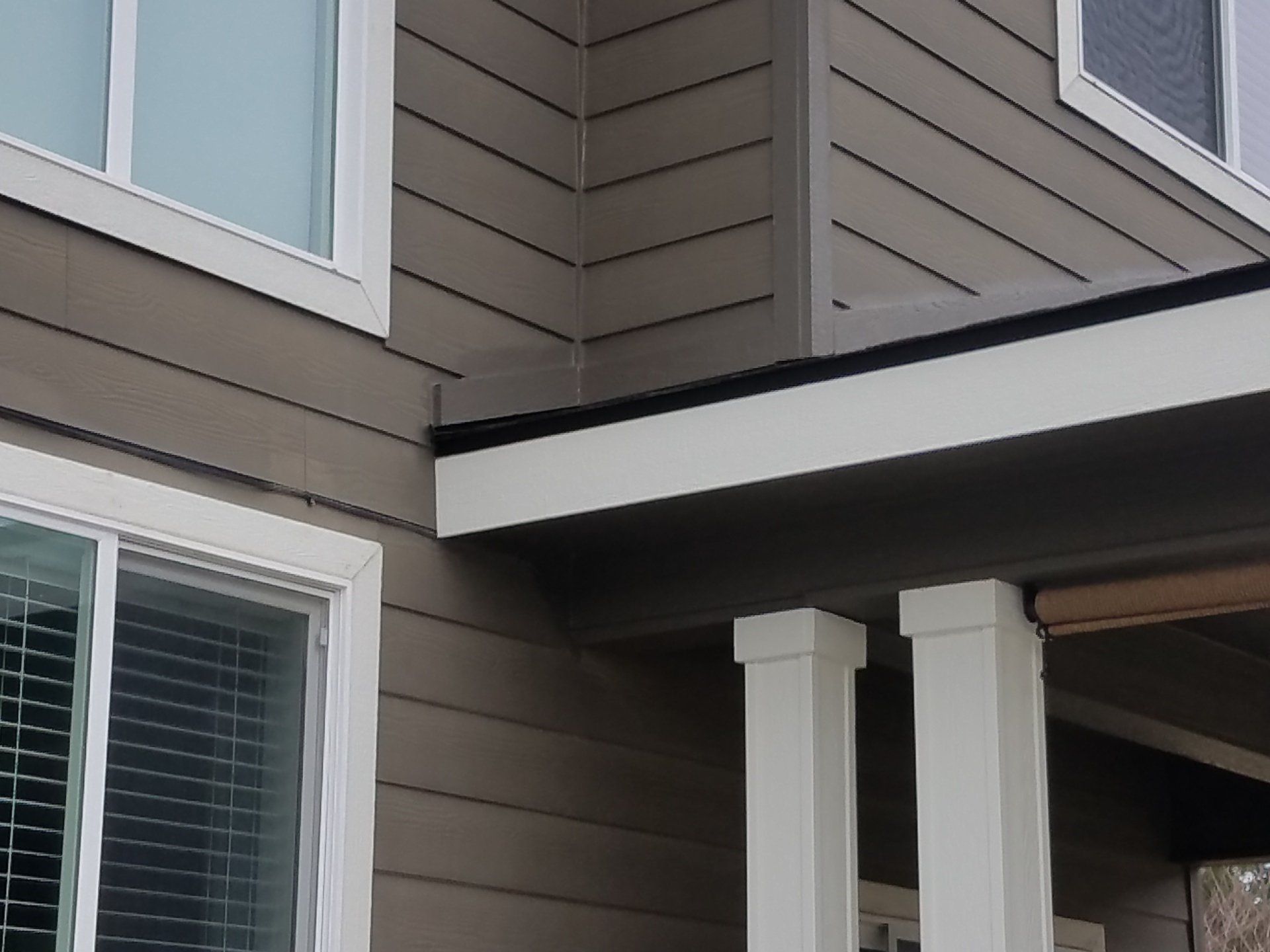 Patio cover addition - view of where support post connects with house siding