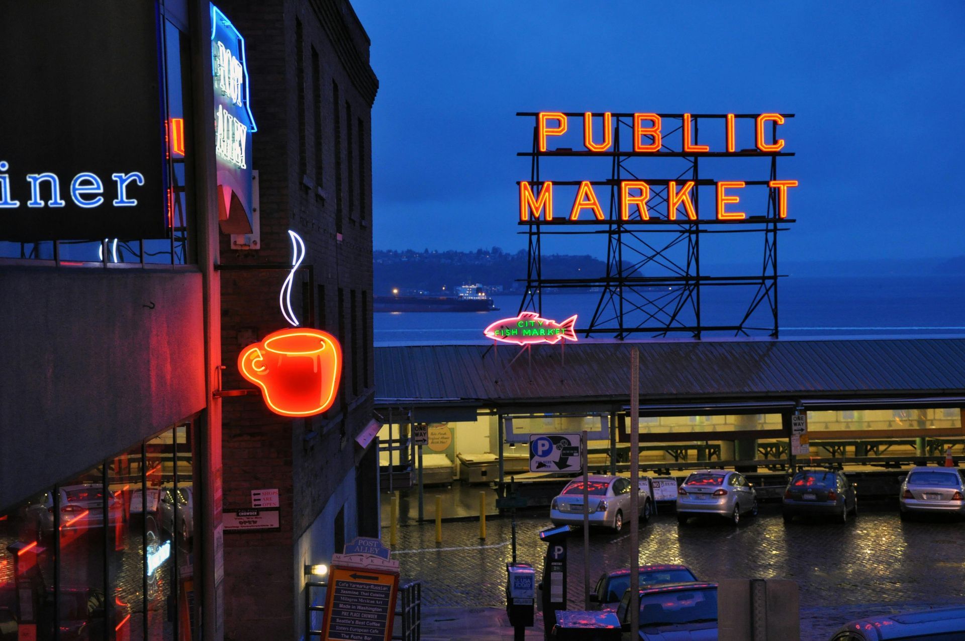 A sign for the public market is lit up at night