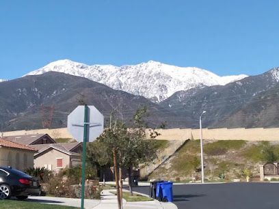 A stop sign in front of a snowy mountain