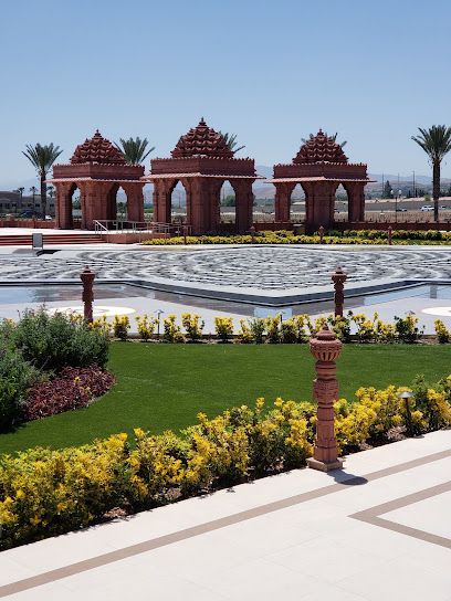 A garden with arches and a pool in the middle