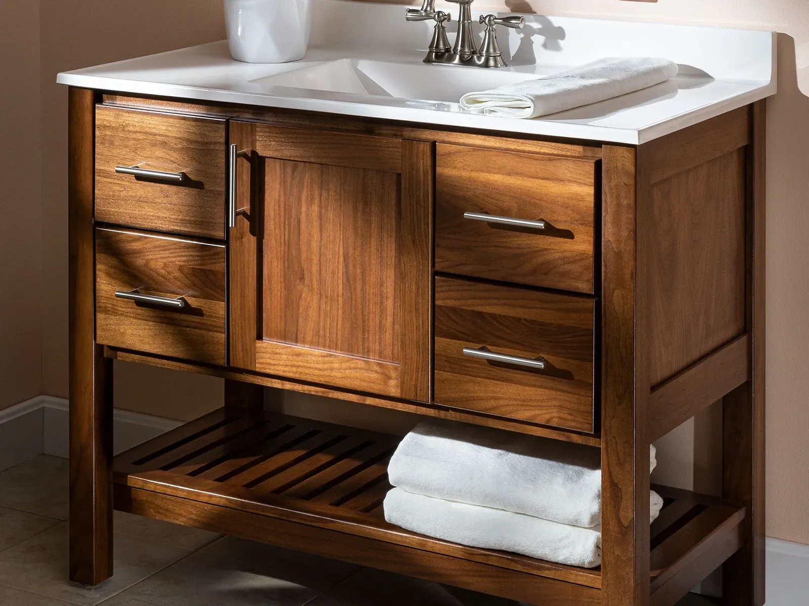 A bathroom vanity with a sink and towels on it