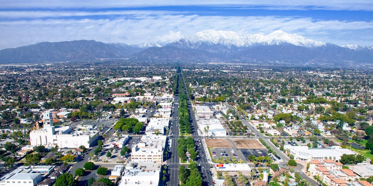An aerial view of a city with mountains in the background.