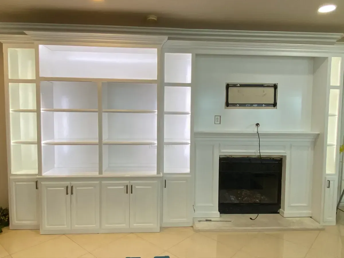 A living room with a fireplace and lots of shelves