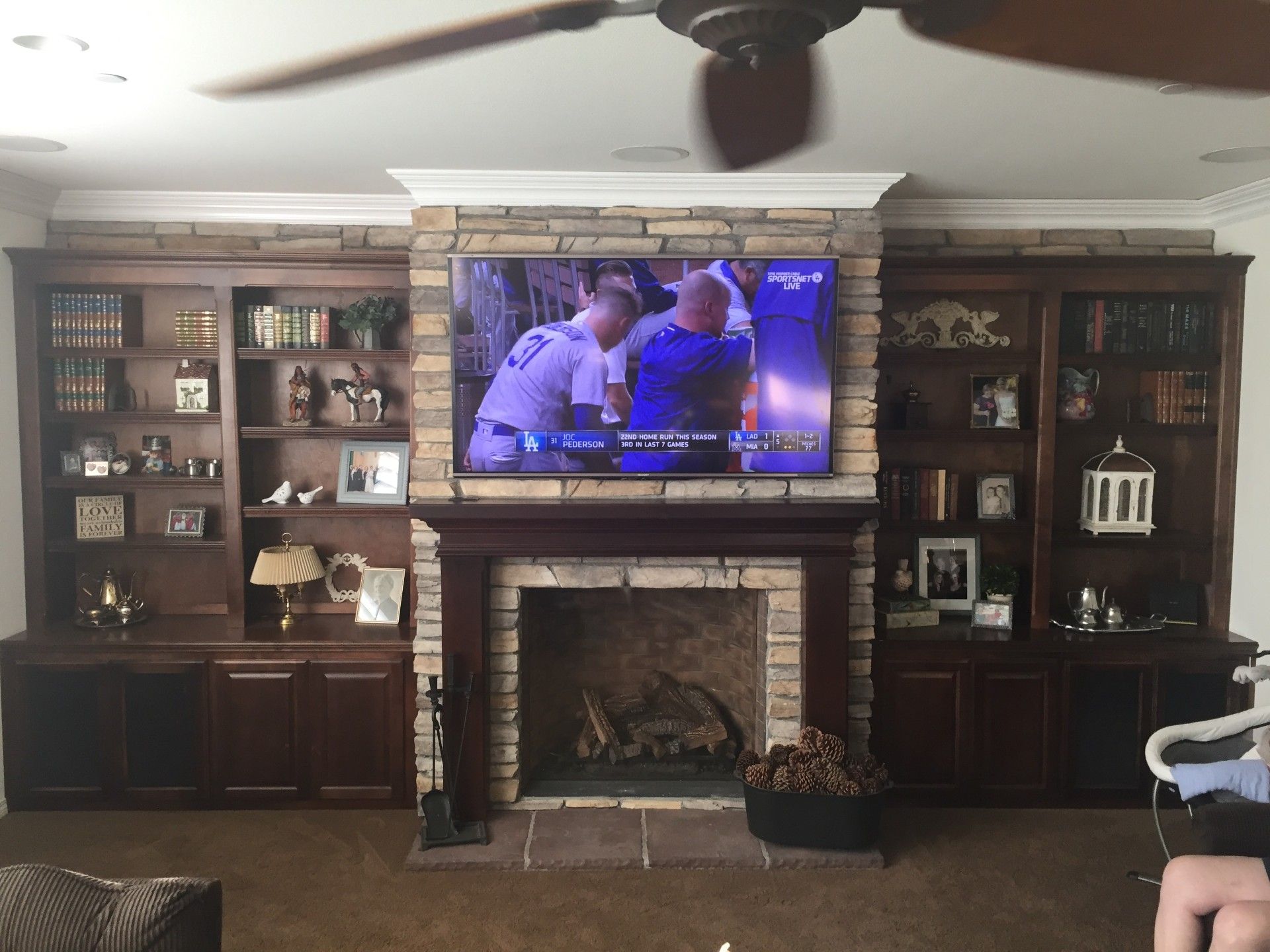 A living room with a fireplace and a flat screen tv