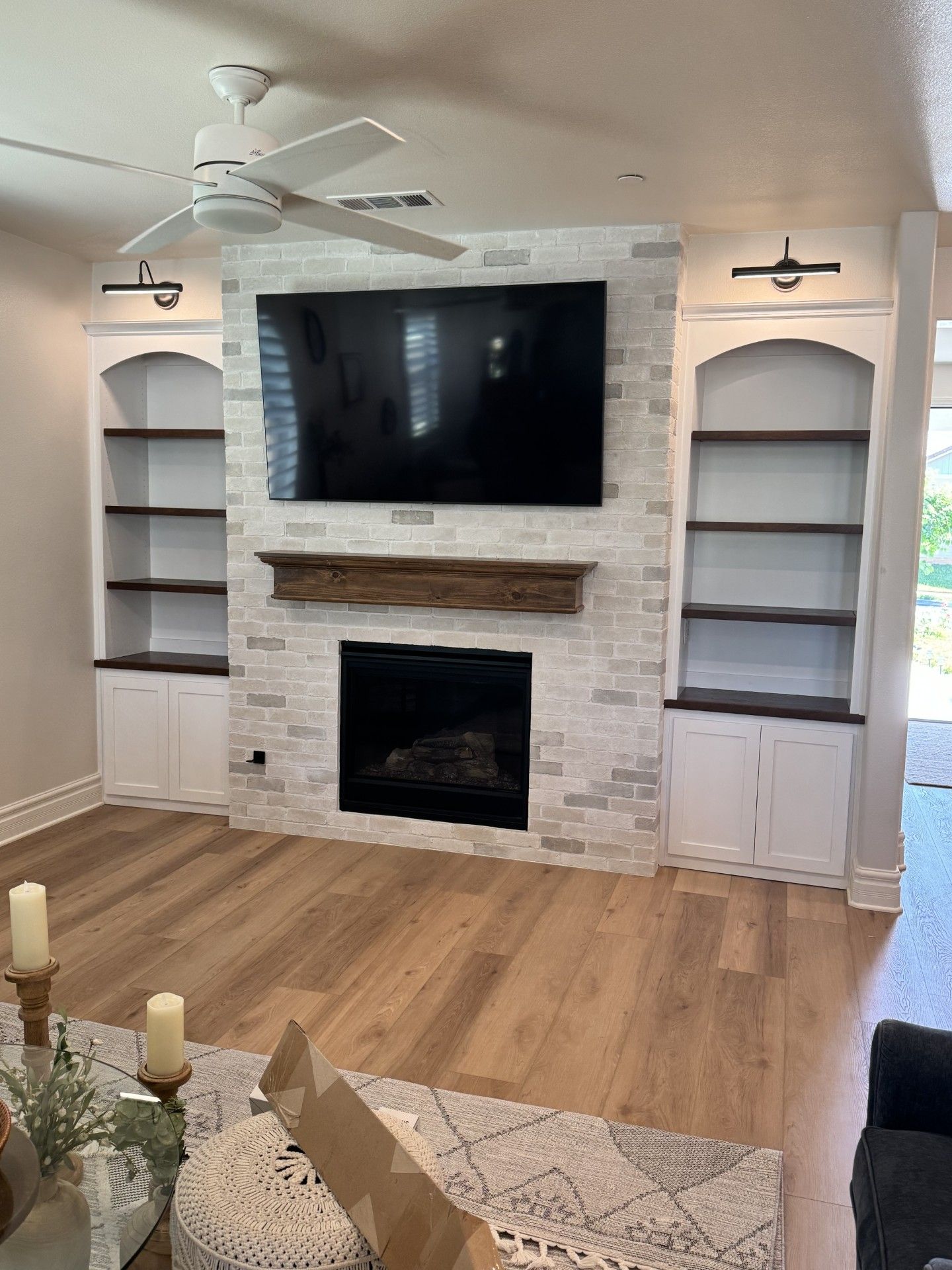 A living room with a fireplace and a flat screen tv.