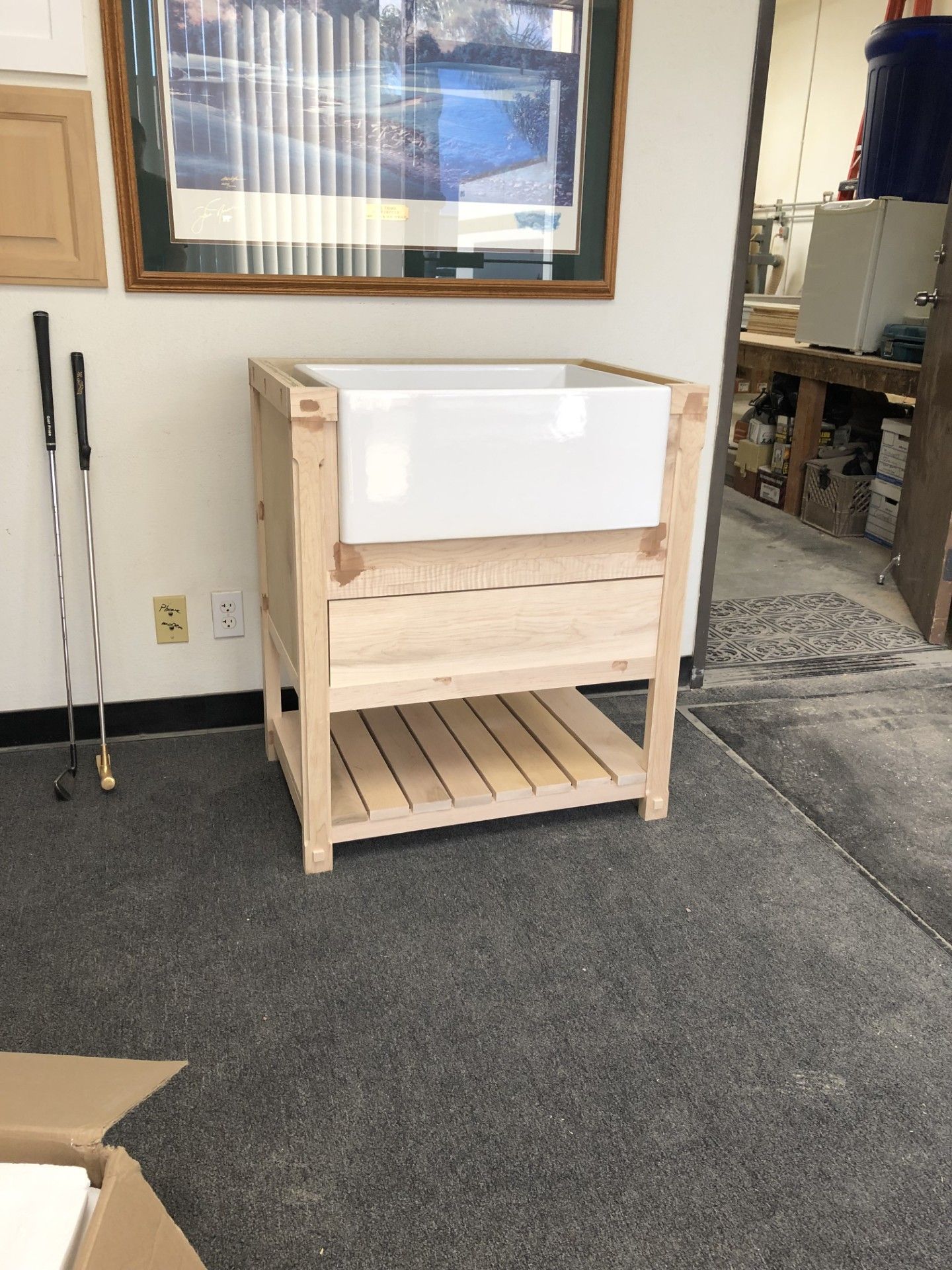 A wooden cabinet with a sink on top of it in a room.